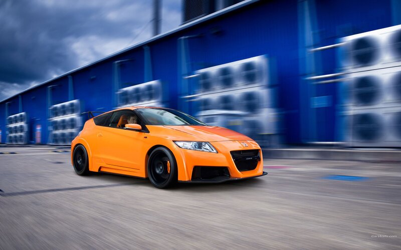 orange sports car in motion