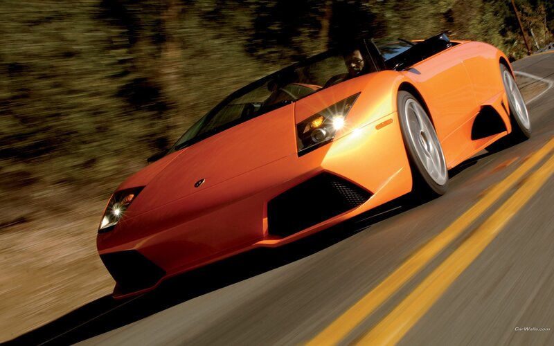 orange sports car in motion