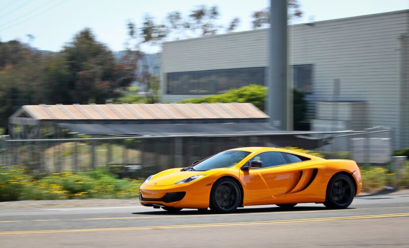 orange sports car in motion