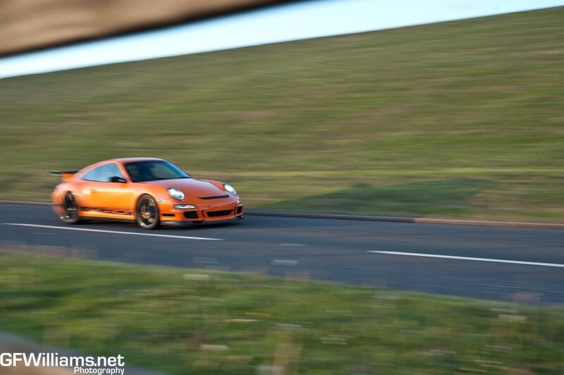 orange sports car in motion