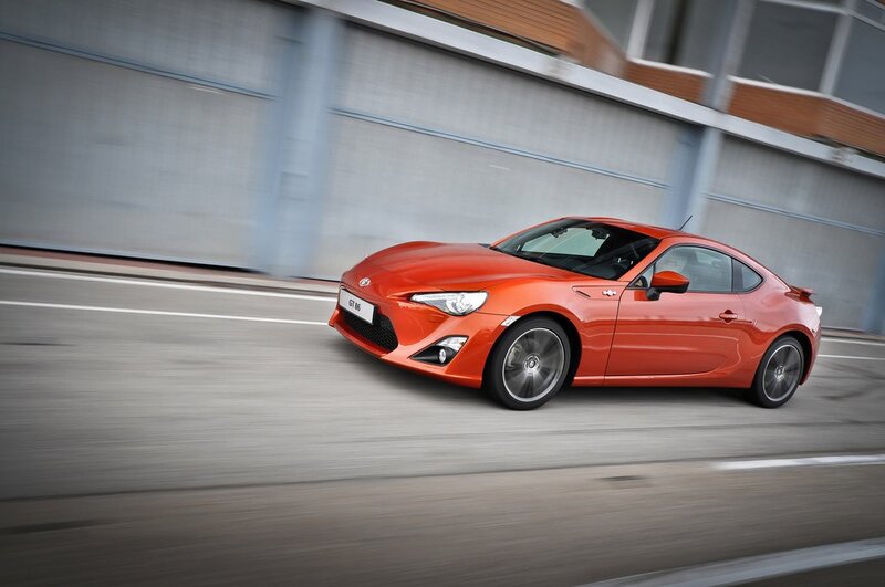 Orange sports car in motion