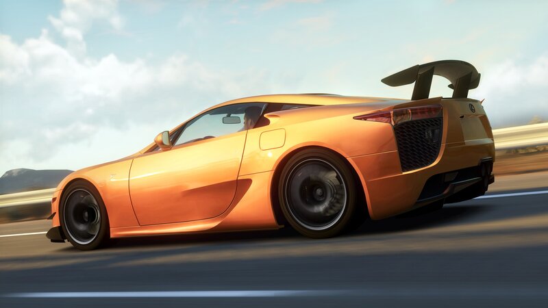orange sports car in motion