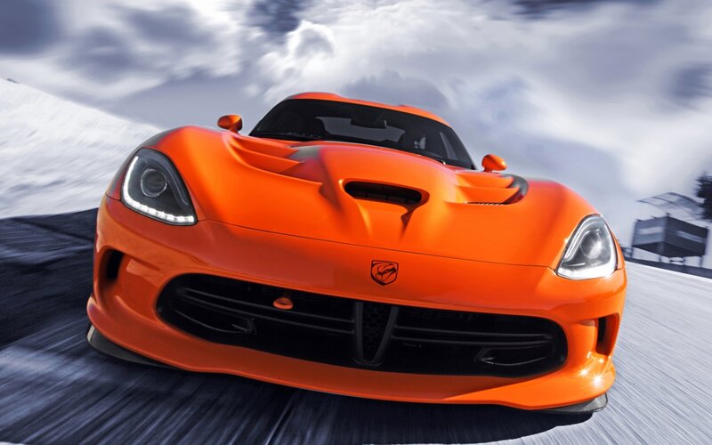 orange sports car in motion