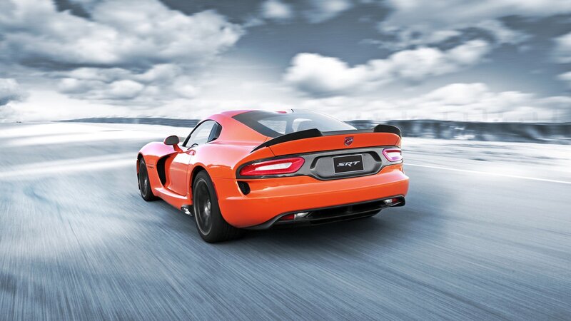 orange sports car in motion