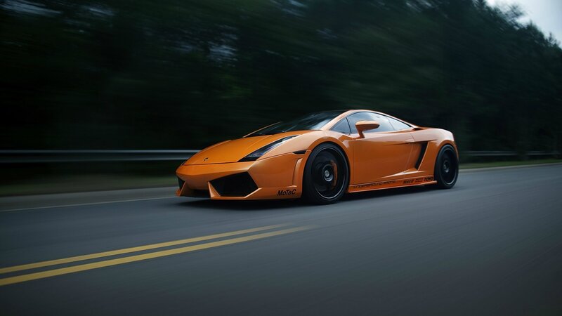 orange sports car in motion