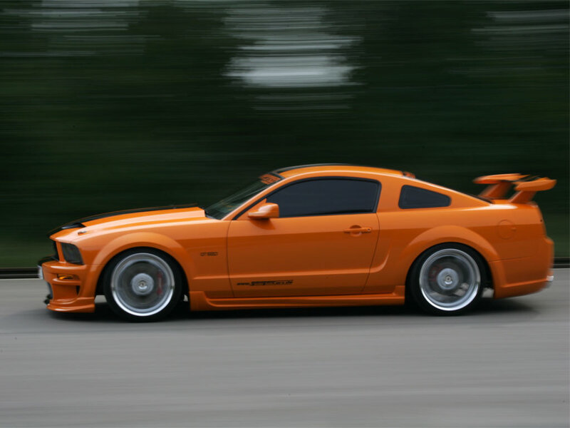 orange sports car in motion