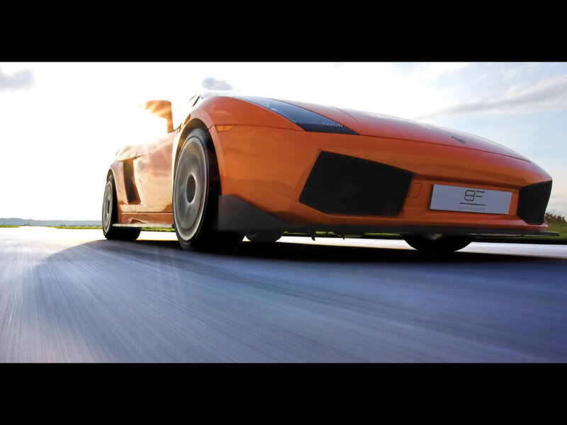 orange sports car in motion