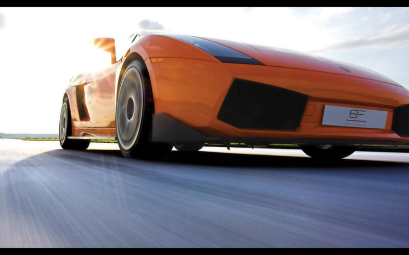 orange sports car in motion