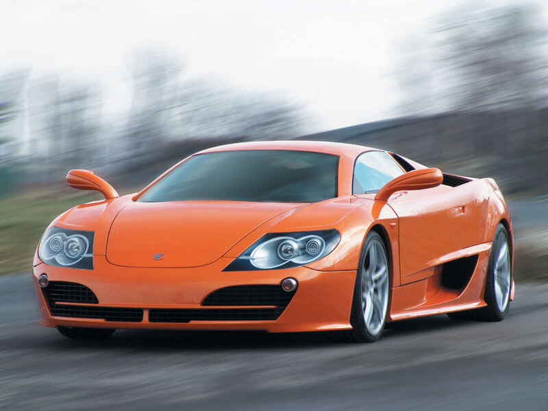 orange sports car in motion