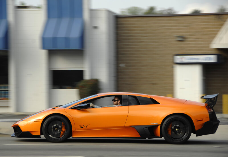 orange sports car in motion