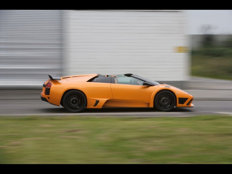orange sports car in motion