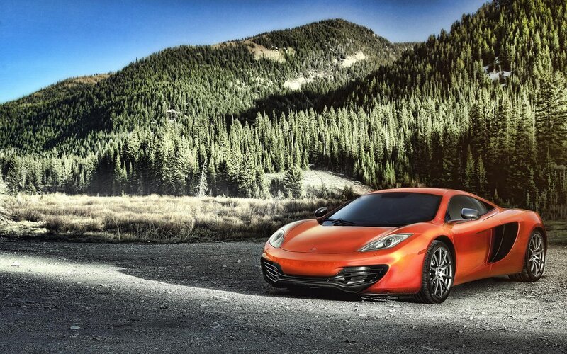 Orange sports car in mountain landscape