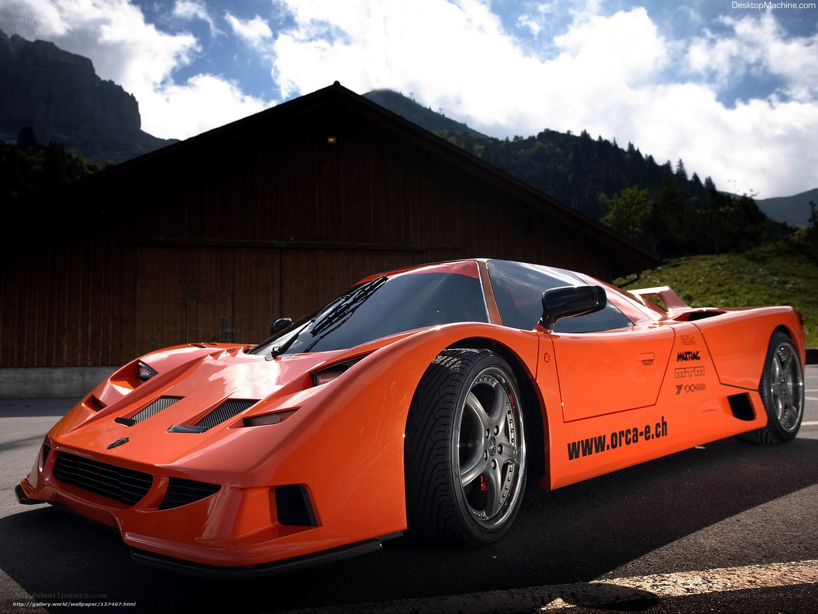 Orange sports car in mountain setting