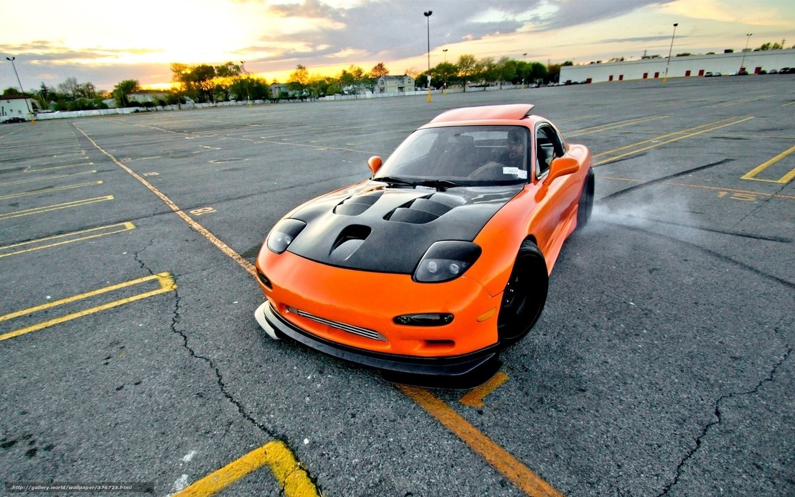 orange sports car in parking lot