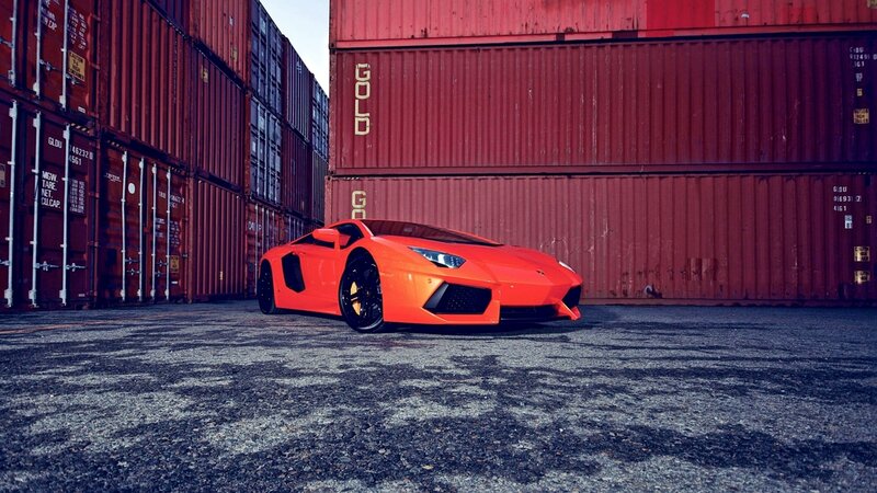 Orange sports car in shipping yard