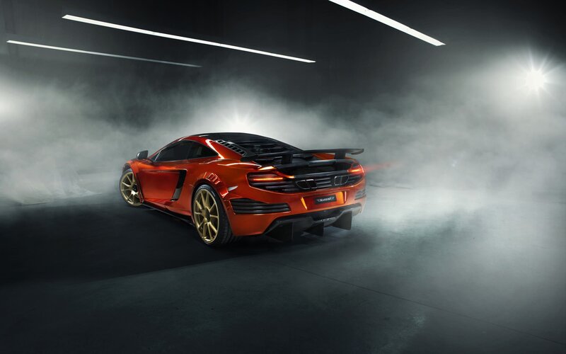 Orange sports car in smoke