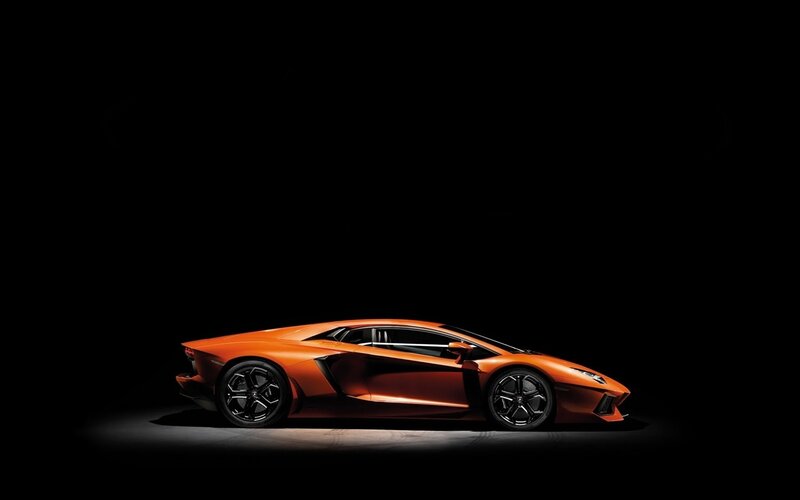 Orange sports car in spotlight
