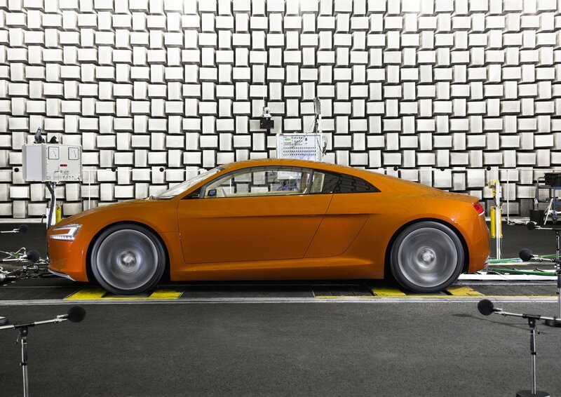 Orange sports car in testing facility
