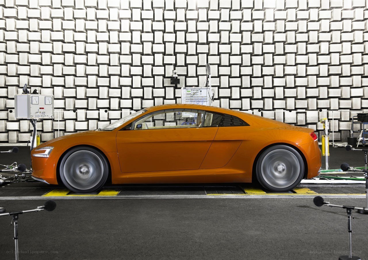Orange sports car in testing facility
