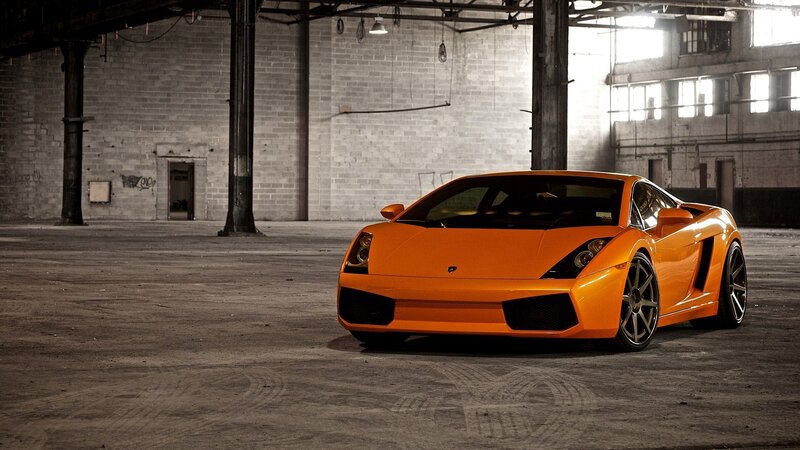 Orange sports car in warehouse