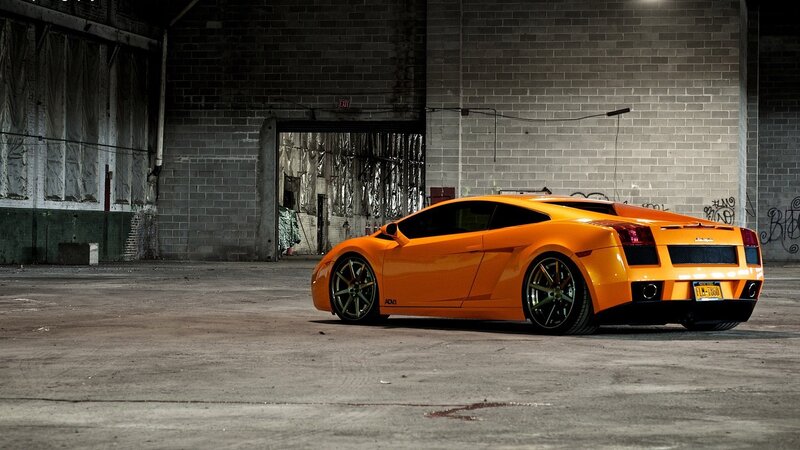 orange sports car in warehouse