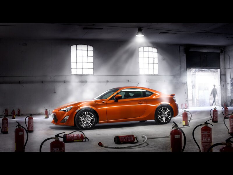Orange sports car in warehouse