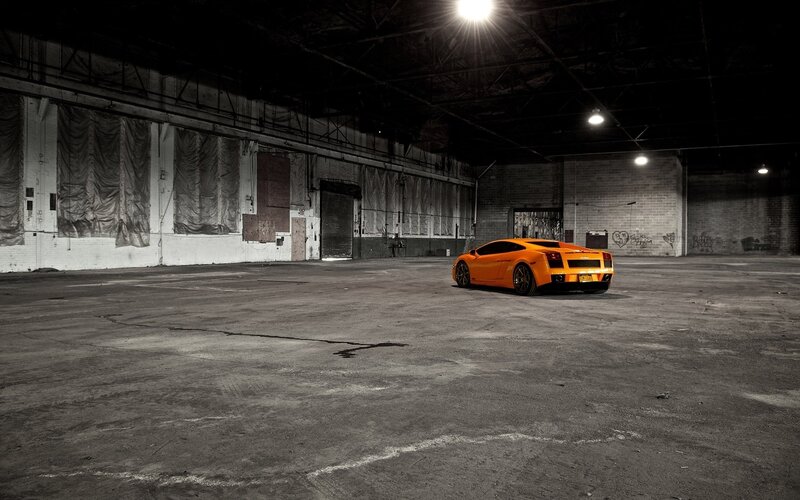 Orange sports car in warehouse