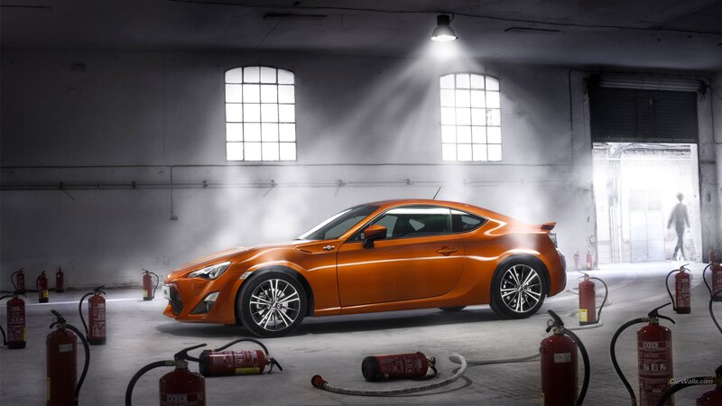 Orange sports car in warehouse
