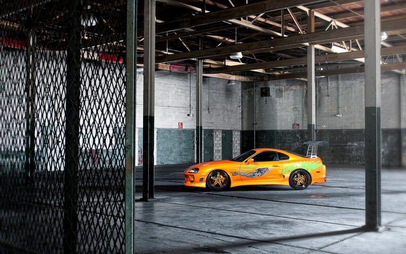 Orange sports car in warehouse