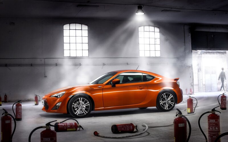 Orange sports car in warehouse