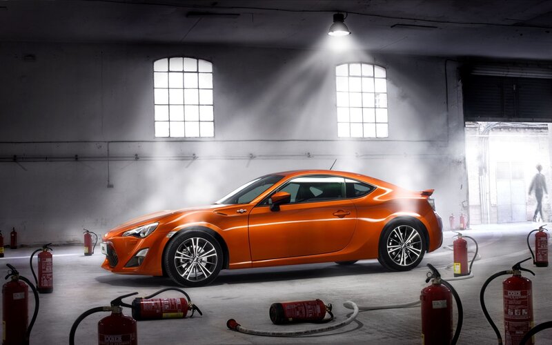 Orange sports car in warehouse