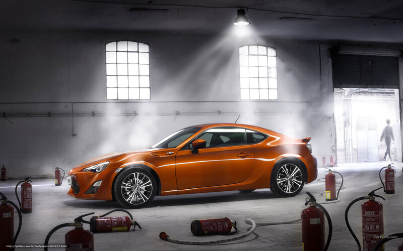 Orange sports car in warehouse