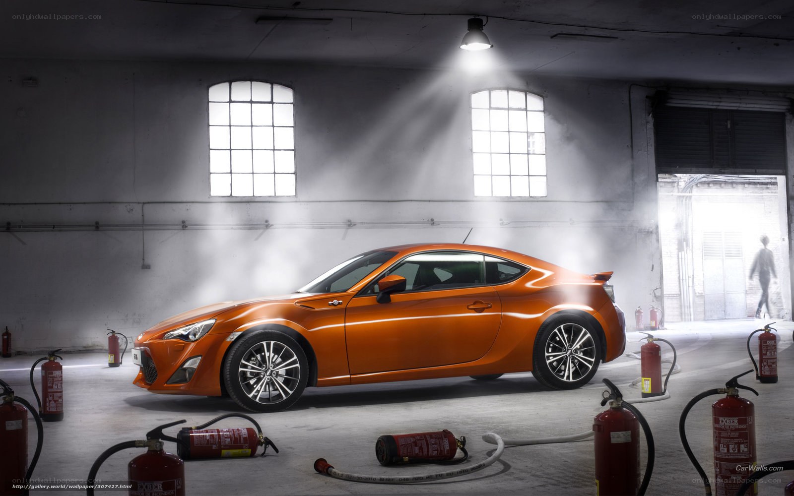 Orange sports car in warehouse