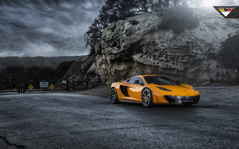 Orange sports car on a closed road