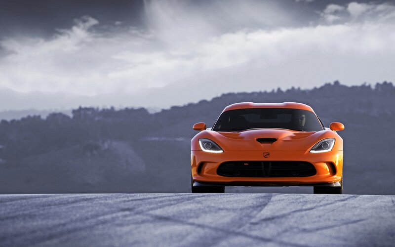 Orange sports car on a road