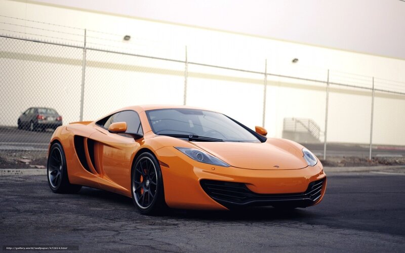 orange sports car on asphalt