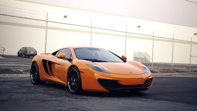 orange sports car on asphalt
