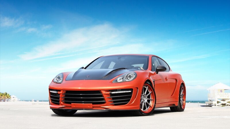 Orange sports car on beach