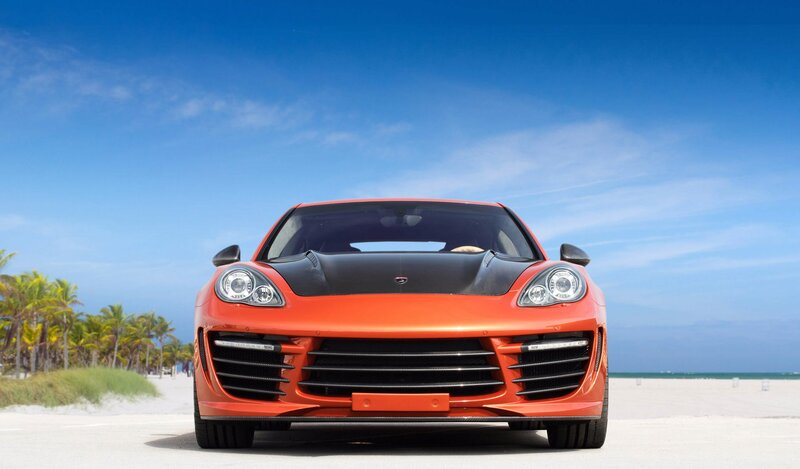 Orange sports car on beach