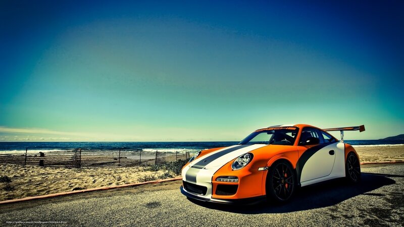 Orange sports car on beach road