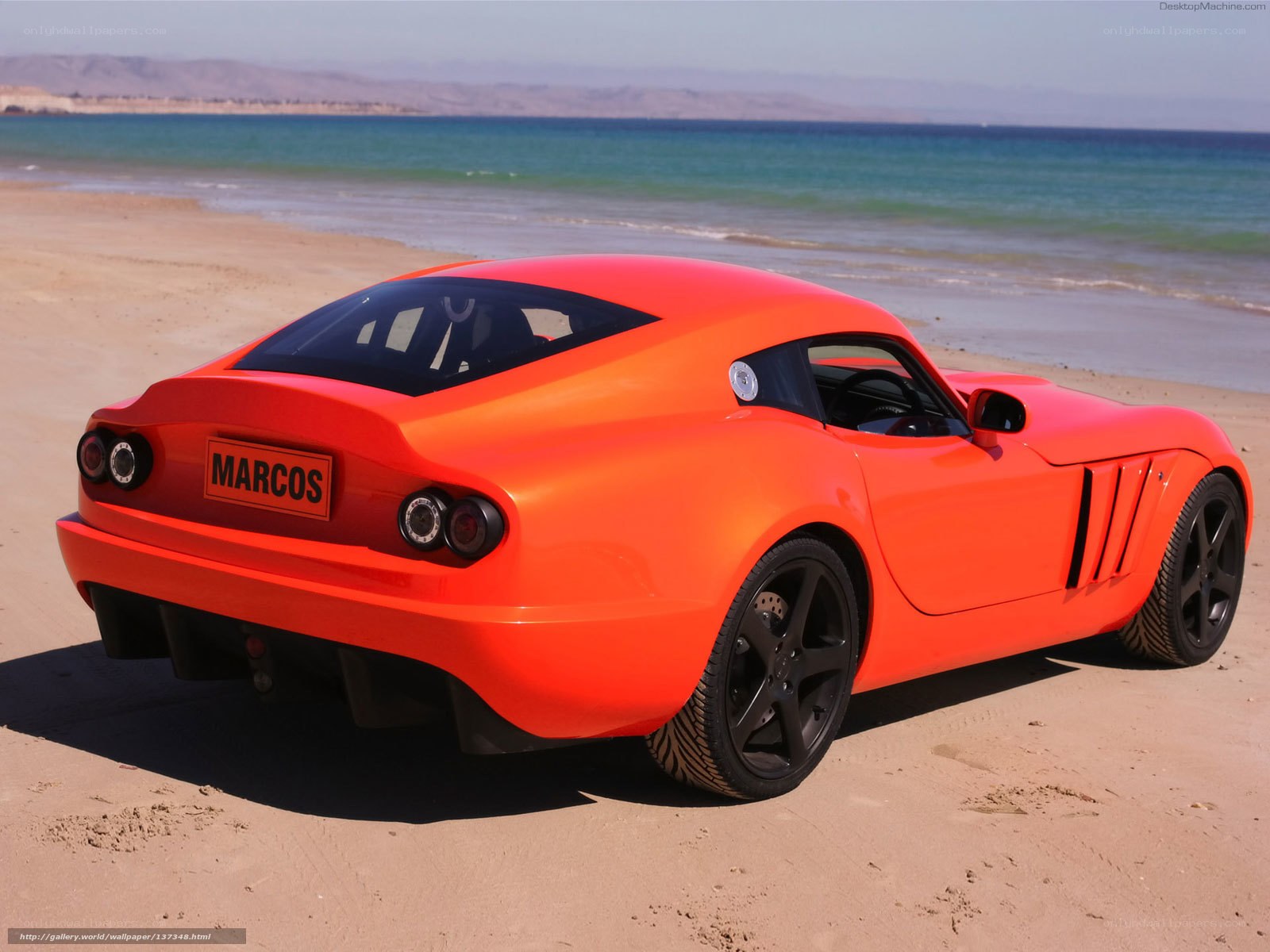 Orange sports car on beach