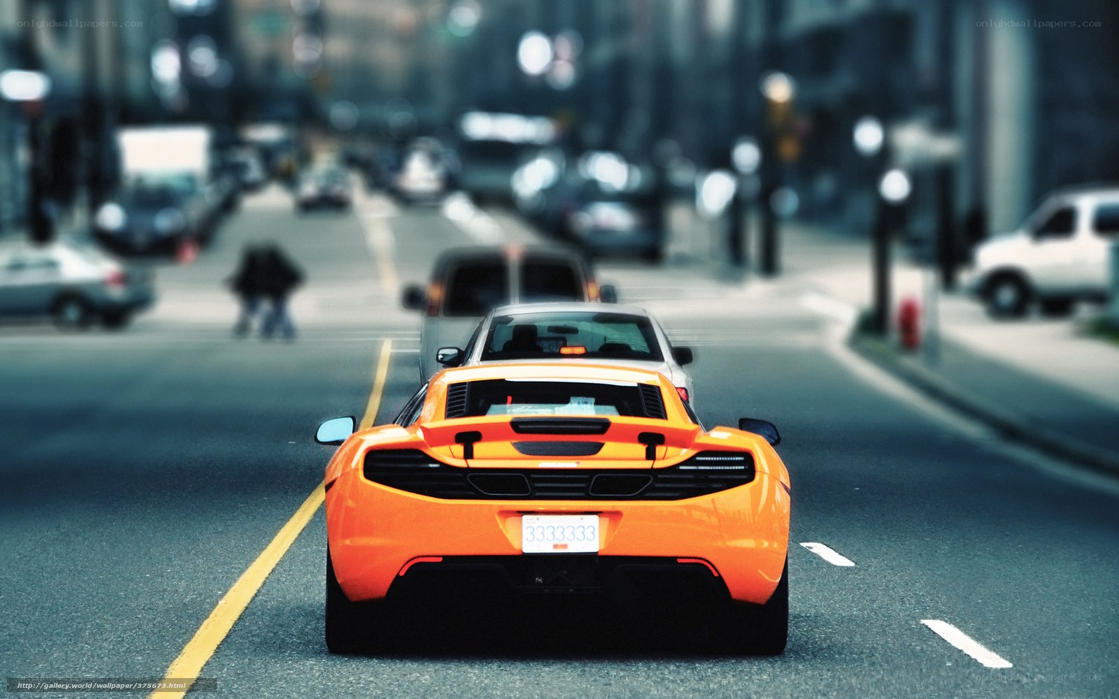 Orange sports car on city street