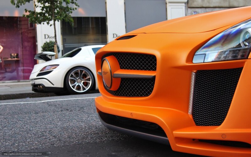 Orange sports car on city street