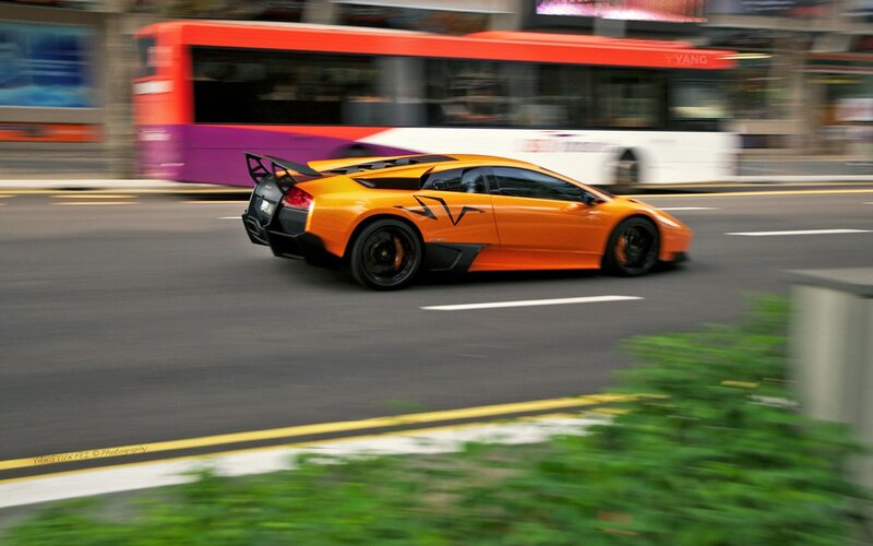 Orange sports car on city street