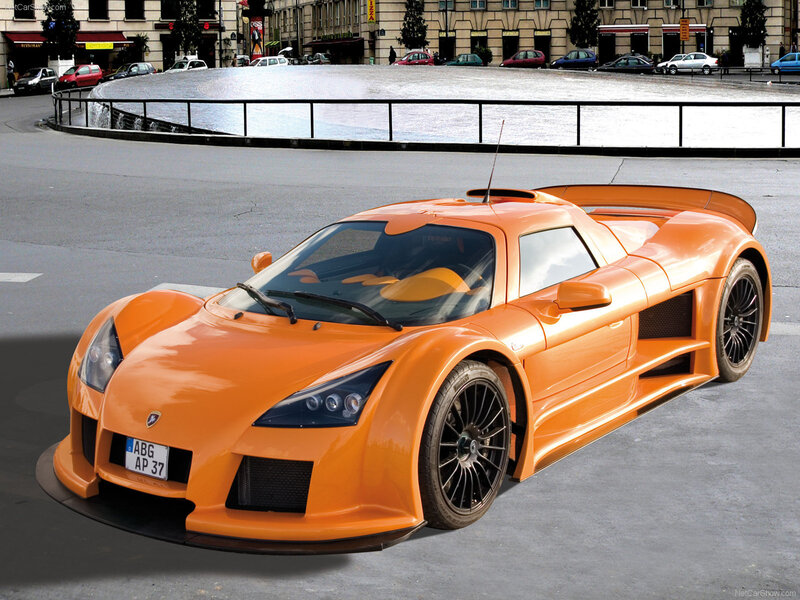 orange sports car on city street