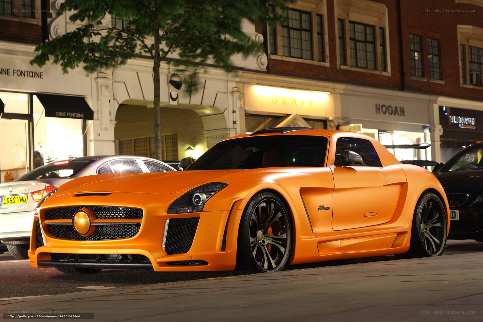 Orange sports car on city street