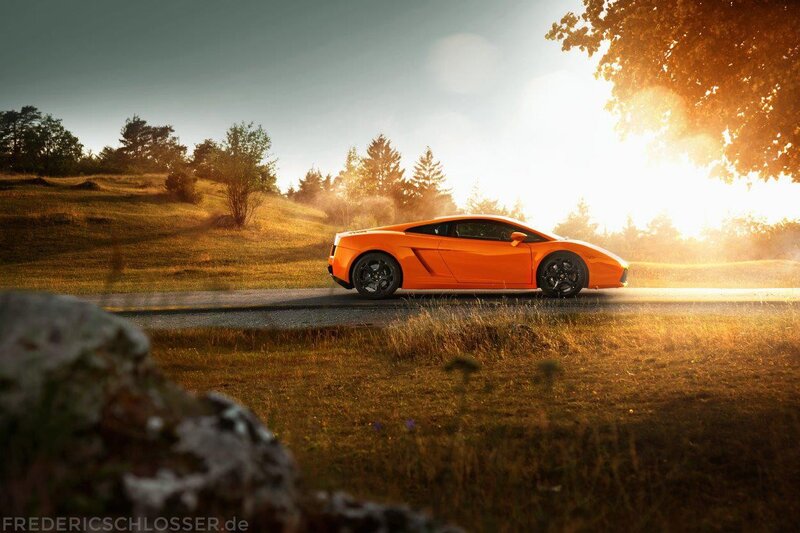 Orange sports car on country road