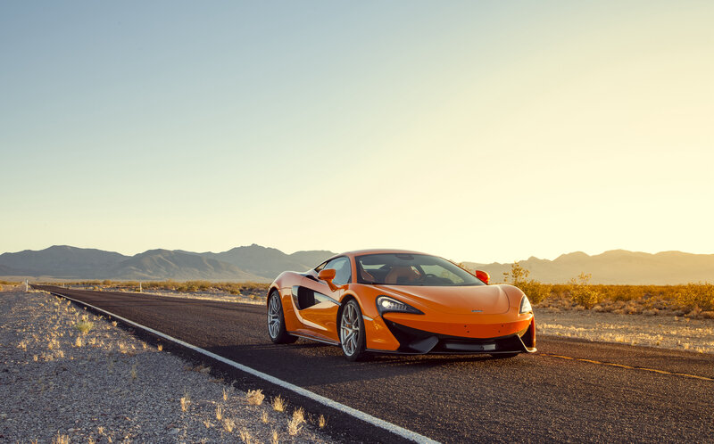 Orange sports car on desert road