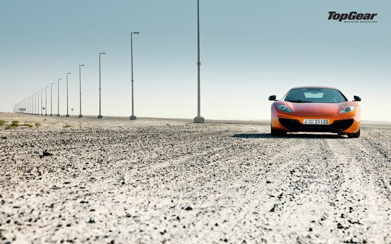 Orange sports car on desert road
