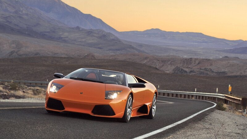 Orange sports car on desert road